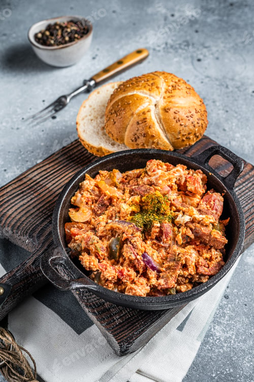 Preview: Turkish breakfast with Menemen omelet and bread. Dark background. Top view