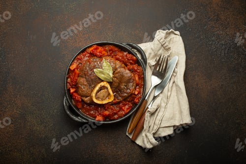 Preview: Traditional Italian dish Ossobuco all Milanese made with cut veal shank meat with vegetable tomato