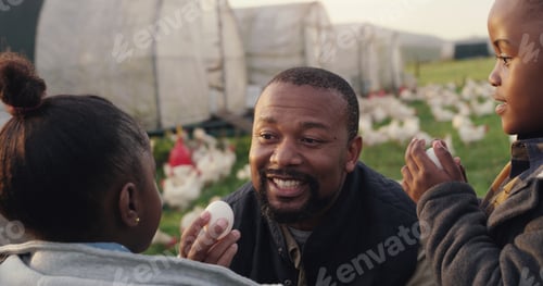 Preview: Shot of a man working with his adorable son and daughter on a chicken farm