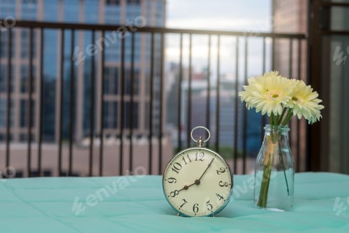 Preview: Retro alarm clock on the bed at morning time
