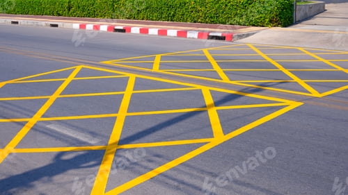 Preview: No stopping yellow crisscross zone traffic sign on asphalt road at the entrance way of hospital