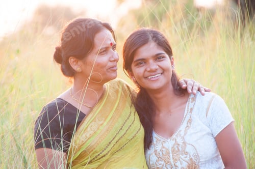 Preview: Portrait of happy mother and daughter in meadow at sunset. Smart Blurred photo