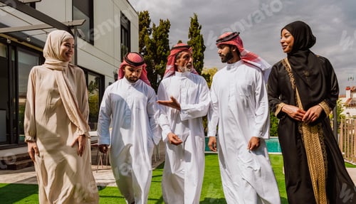 Preview: Arab multi-generational family gathering and discussing outdoors