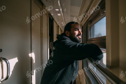 Preview: The Man Looks Out The Window On The Train. Young Handsome Guy In The Corridor Of A Train Carriage