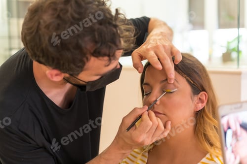 Preview: A closeup shot of a male Caucasian makeup artist doing makeup