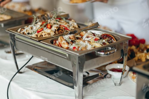 Preview: A close-up view of a chafing dish filled with meat