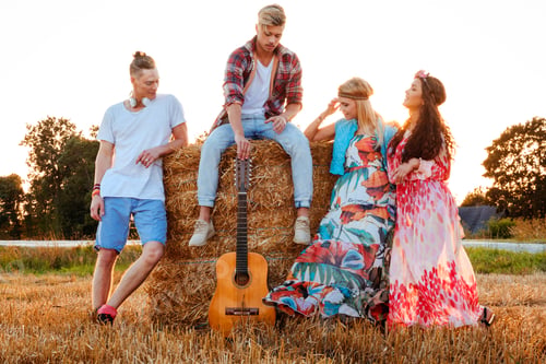 Preview: Hippie friends with guitar in a wheat field