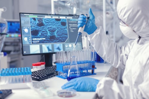 Preview: Healthcare researcher in ppe suit working with micro pipette