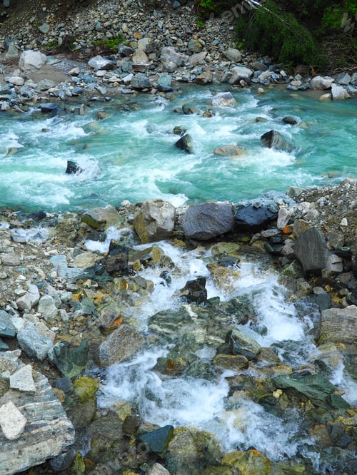 Preview: Vertical shot of rocks in a stream flowing water
