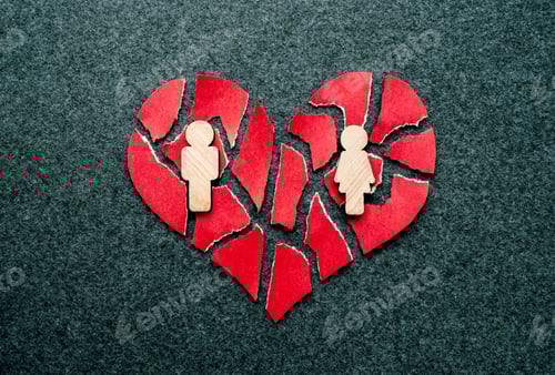 Preview: Paper red broken heart with wooden figures of man and woman on dark felt background. Mosaic paper