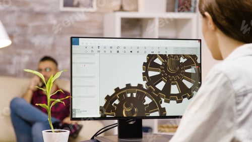 Preview: Back view of female engineer working on a mechanical concept