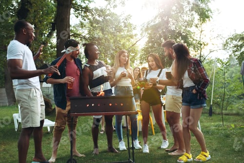 Preview: Group of friends making barbecue in the backyard. concept about good and positive mood with friends