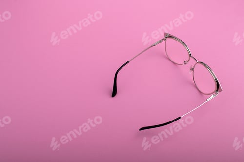 Preview: Black frame eyeglasses isolated on pastel pink color background