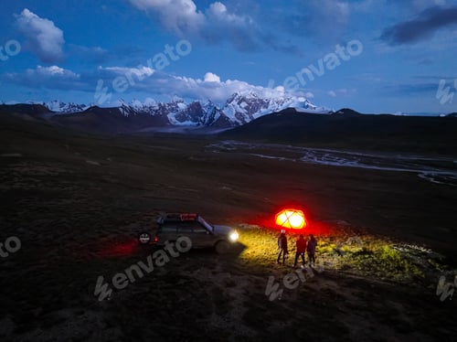 Preview: Night camping with illuminated tent and SUV under starry sky