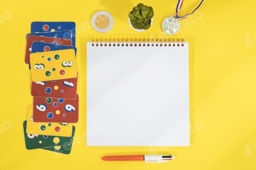 Preview: Old dirty ligretto cards, winner's medal, chocolate coins, empty notebook and pen.