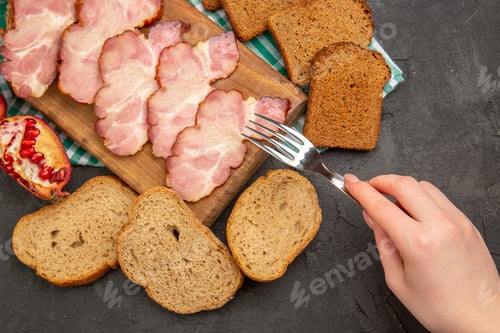 Preview: top view fresh sliced ham with seasonings and bread on dark background color food photo meat