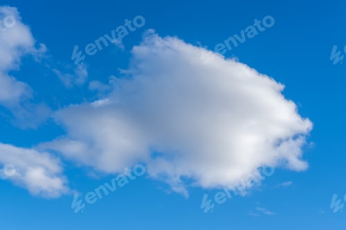 Preview: Blue sky with fluffy white clouds. large white cumulus cloud in center. Cloud background to overlay