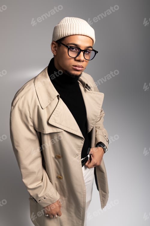 Preview: Handsome young man showcases stylish fashion in modern studio setting