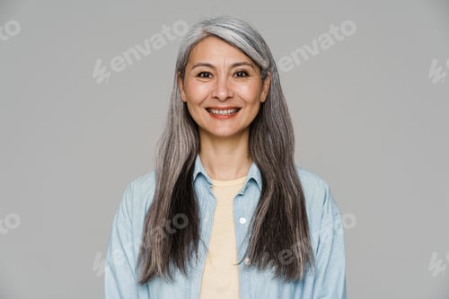 Preview: Mature white-haired woman smiling and looking at camera