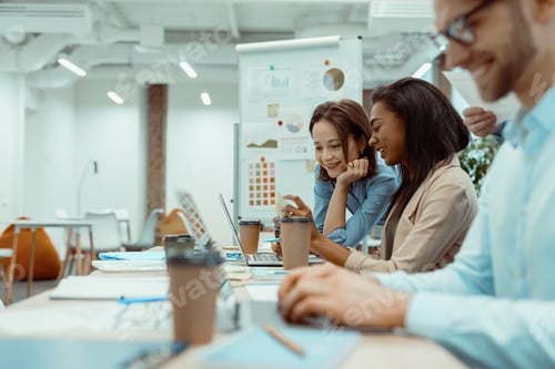 Preview: Creative business team using laptop in office