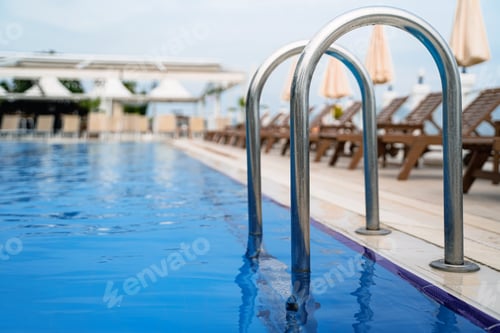 Preview: grab bars outdoor swimming pool entrance with sunlounger chairs terrace in the background