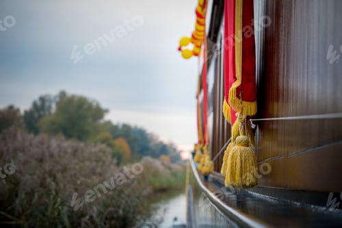 Preview: Closeup selective focus shot of golden tassels hanging over a boat in Elburg, Netherlands