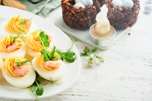 Preview: Stuffed or deviled eggs yolk, shrimp, pea microgreens with paprika for easter table decorate fresh c
