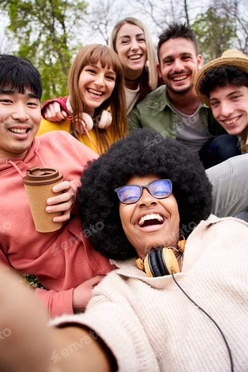 Preview: Vertical happy selfie of multi-ethnic group young friends looking laughing at camera. Portrait gen z