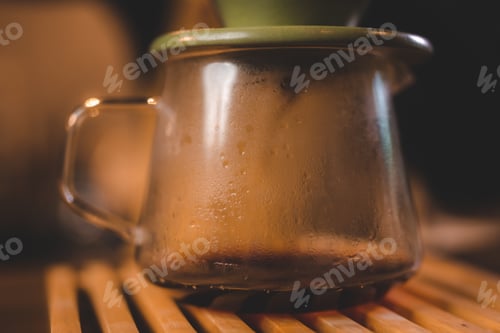 Preview: hipster barista pouring a hot water to making coffee with drip or filter style in cafe, slow brew