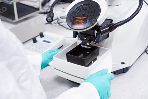 Preview: Scientist inserts the sample for biological analysis into the microscope