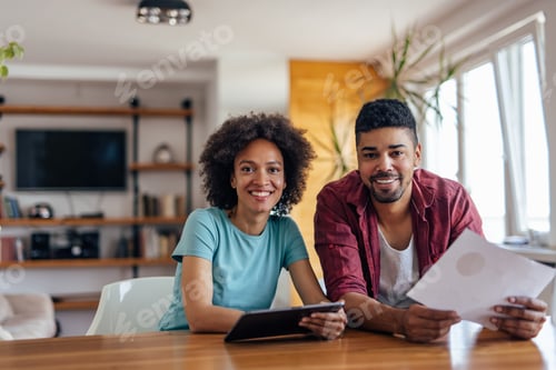 Preview: Adult couple, posing for the picture, at home office.