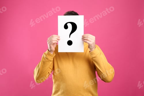 Preview: Man holding paper with question mark on pink background
