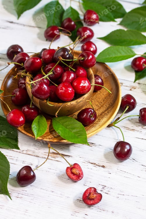 Preview: Ripe juicy berry cherry in a bowl on a kitchen rustic table.