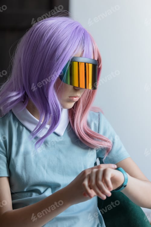 Preview: Girl in VR glasses and purple hair indoor next to window