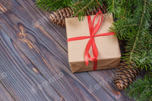 Preview: Christmas tree branch, decorations and gift box on white wooden table