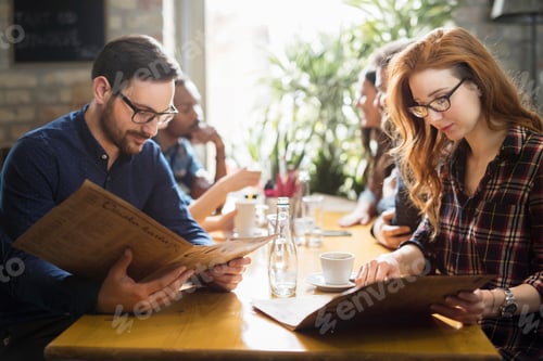 Preview: Happy colleagues from work socializing in restaurant