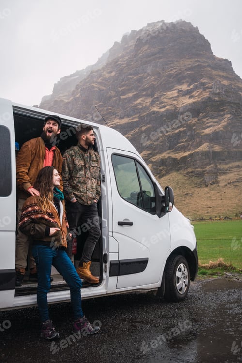 Preview: Laughing friends with van in nature