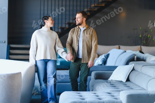 Preview: Young couple holding hands shopping in furniture store
