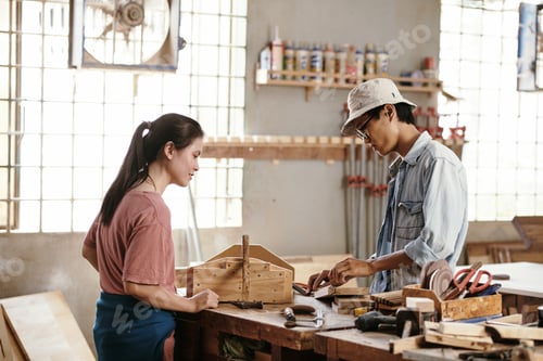 Preview: Carpenters working with wooden plank