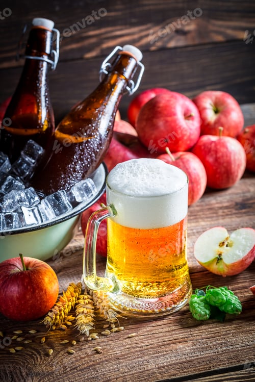 Preview: Cold and fresh beer with apples on old wooden table
