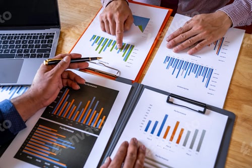 Preview: Marketing analysis two business people discussing Financial charts to analyze profits, investment re
