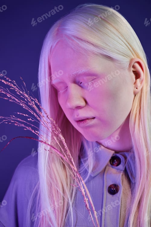 Preview: Caucasian Woman with Albinism Holding Gilded Plant