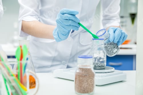 Preview: Mid section view of female scientist working with reagent in laboratory