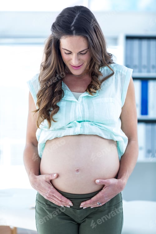 Preview: Pregnant Woman Touching Her Belly In Hospital