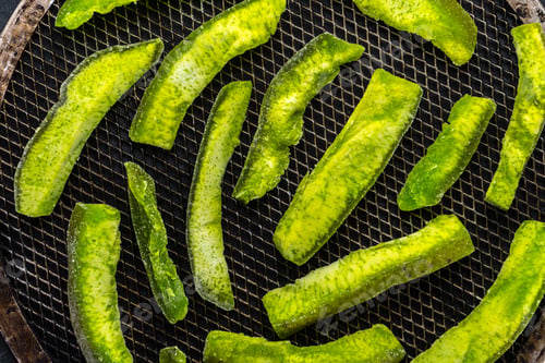 Preview: Candied fruits from a bright green pomelo on the grill from above