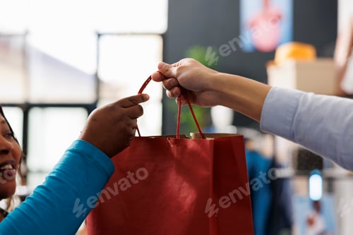 Preview: Employee giving red paper bag to client