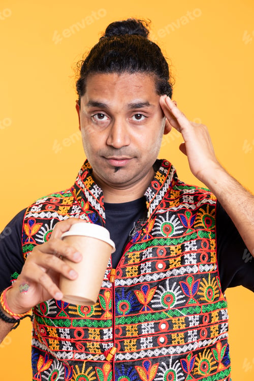 Preview: Tired person rubbing head temples, feeling strain, sipping caffeine beverage