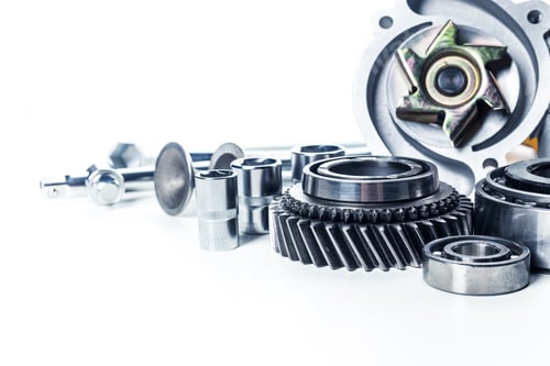 Preview: Collection of mechanical parts and tools arranged on a white surface for repair and maintenance