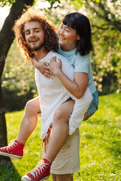 Preview: Happy young multiethnic couple in park