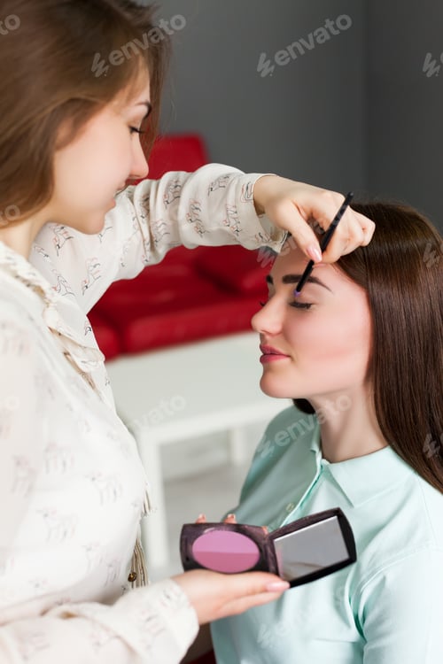 Preview: Make up artist applying make-up on girl face